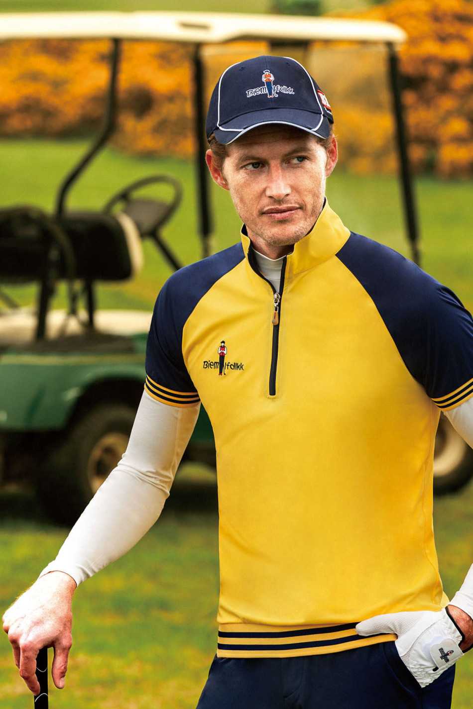 模特身着玫红色功能夹克于球场漫步，衣摆随风轻扬，色彩如霞光般绚烂夺目